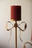 SET OF THREE ANTIQUE BRASS PILLAR CANDLE STANDS -BOW DETAIL