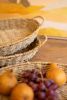 SET OF THREE WOVEN VINE OVAL TRAYS WITH HANDLES