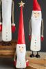 SET OF THREE PAINTED METAL AND WOOD SANTAS WITH ROPE ARMS