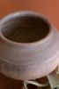 BLACK CLAY URN ON AN IRON STAND