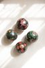 SET OF FOUR HAND PAINTED WOODEN SPHERES