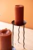 SET OF THREE RUSTIC METAL CANDLE STANDS WITH WAVY LEGS
