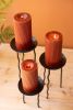 SET OF THREE RUSTIC METAL CANDLE STANDS WITH WAVY LEGS